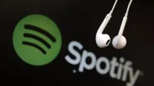headphones are seen in front of a logo of online music streaming service spotify in this illustration picture