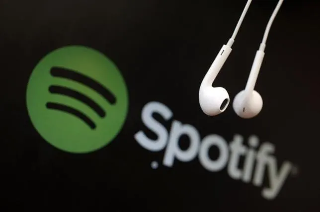 headphones are seen in front of a logo of online music streaming service spotify in this illustration picture